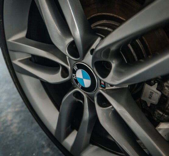 Close-up of a BMW wheel and tire, illustrating its refined design and shine, epitomising top-tier vehicle detailing services.